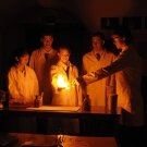 Scientists creating a flame in the dark
