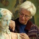 woman restoring statue